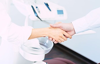 Close-up of dentist and patient shaking hands