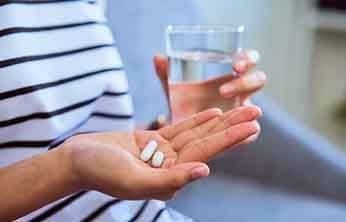 Close-up of hand holding painkillers