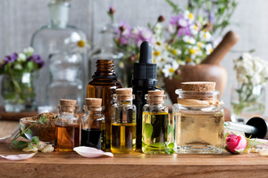 Multiple bottles of essential oils on wooden table