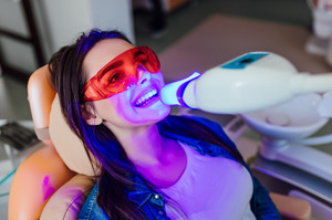 Female patient receiving teeth whitening in-office